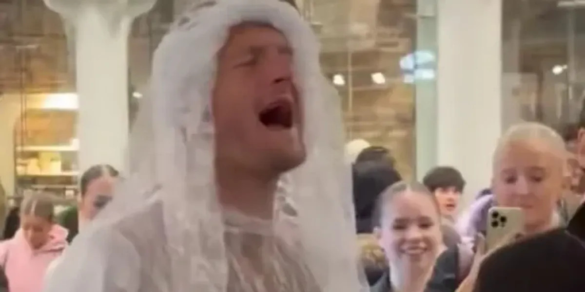 Joe Worrall performs in wedding dress at London station following Burnley defeat