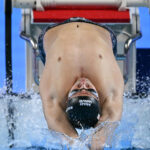 Swimming’s governing body lifts flag ban on Russian athletes, diverging from Olympic guidance