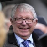 Alex Ferguson celebrates Wade Out's victory at Aintree on Grand National day