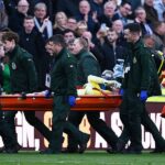 Liverpool goalkeeper stretchered off during Merseyside derby, third-choice keeper brought on