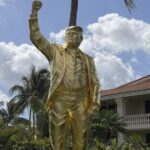 Trump unveils 15-foot gold statue at Florida golf resort amid mixed reactions