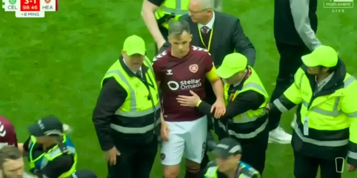 Hearts captain Lawrence Shankland escorted off pitch amid Celtic celebrations after alleged assault