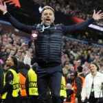 Lee Hendrie restrained by stewards after taunting Nottingham Forest fans during Villa's victory
