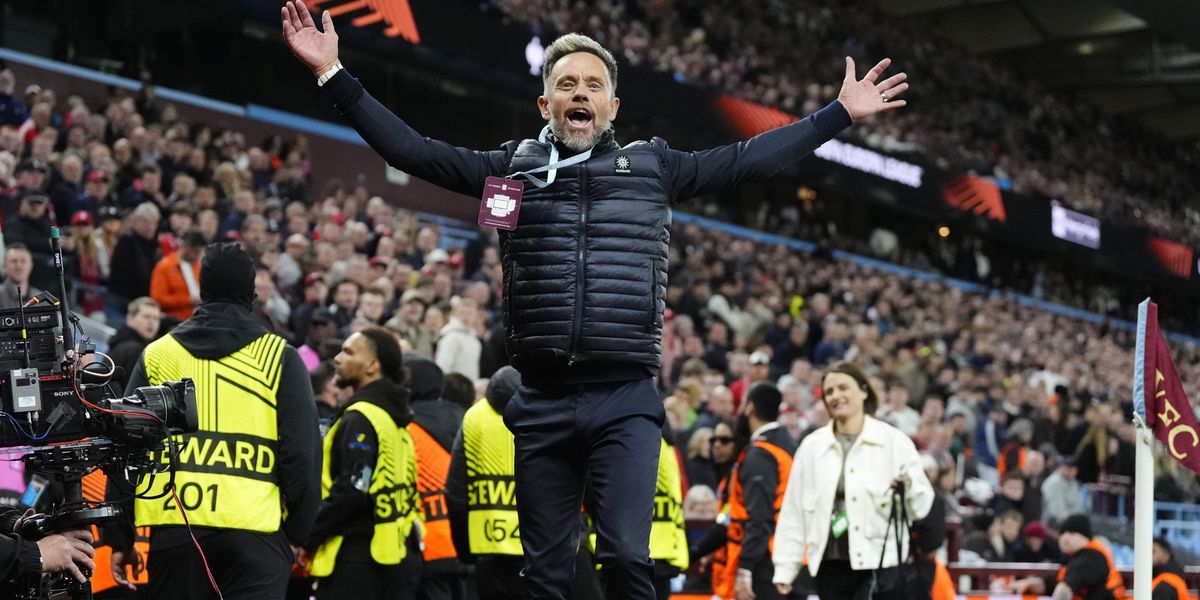 Lee Hendrie restrained by stewards after taunting Nottingham Forest fans during Villa's victory