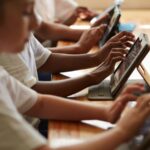 Schools encourage screen reduction at home while promoting technology use in classrooms