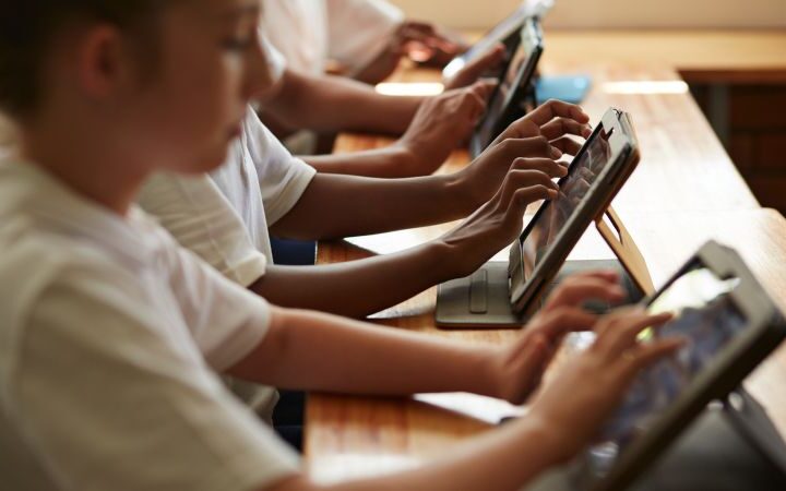 Schools encourage screen reduction at home while promoting technology use in classrooms