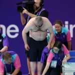 Volunteer delays Adam Peaty's heat by jumping into pool to fix lane rope