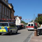 German police evacuate buildings as they investigate potentially explosive device on rail tracks
