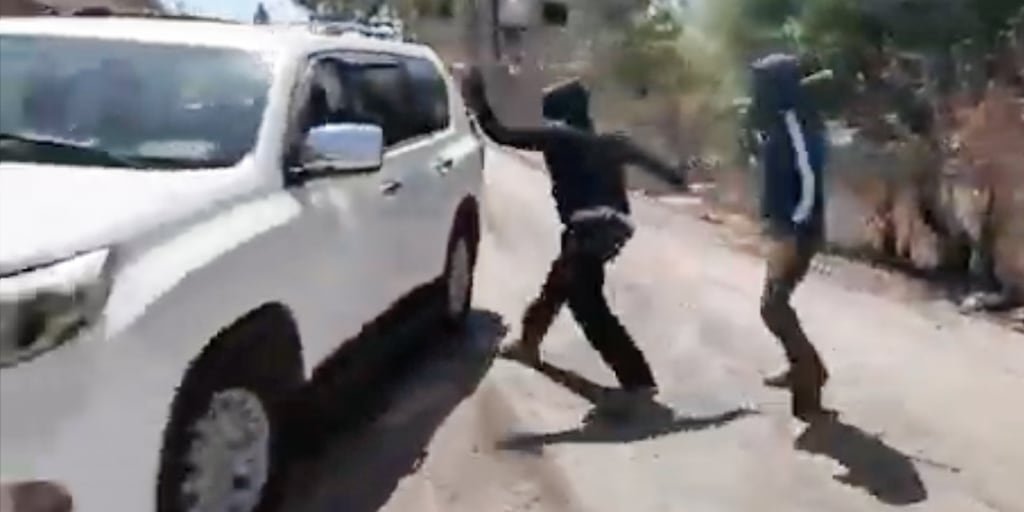 Masked Israeli settlers attack Palestinian woman and NBC News team in West Bank