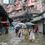 Heavy rain and flooding in Bangkok disrupt traffic and force evacuations