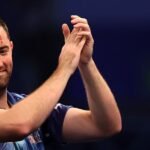 Luke Humphries reacts to crowd member following World Grand Prix victory