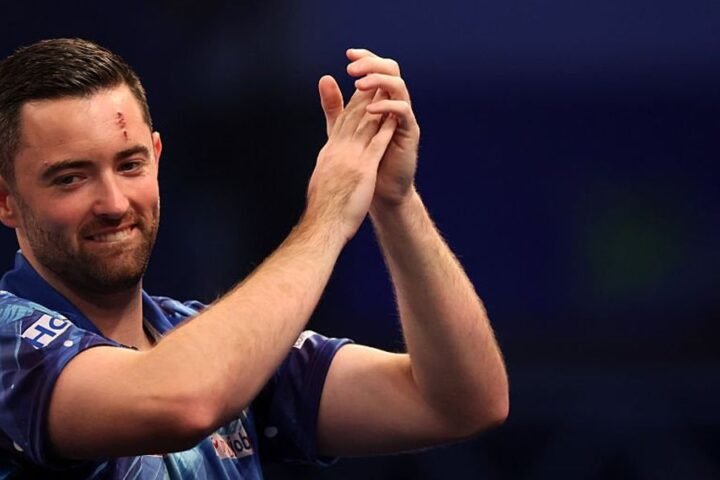 Luke Humphries reacts to crowd member following World Grand Prix victory
