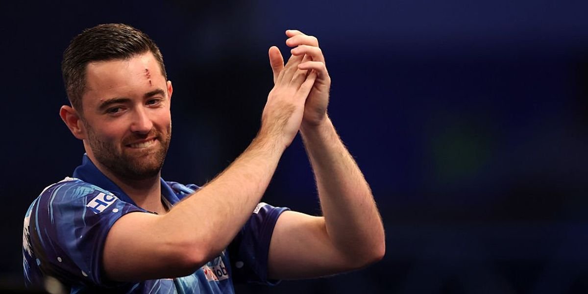 Luke Humphries reacts to crowd member following World Grand Prix victory