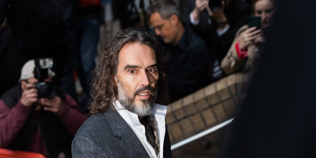 Russell Brand appears in London court for trial on rape and sexual assault charges